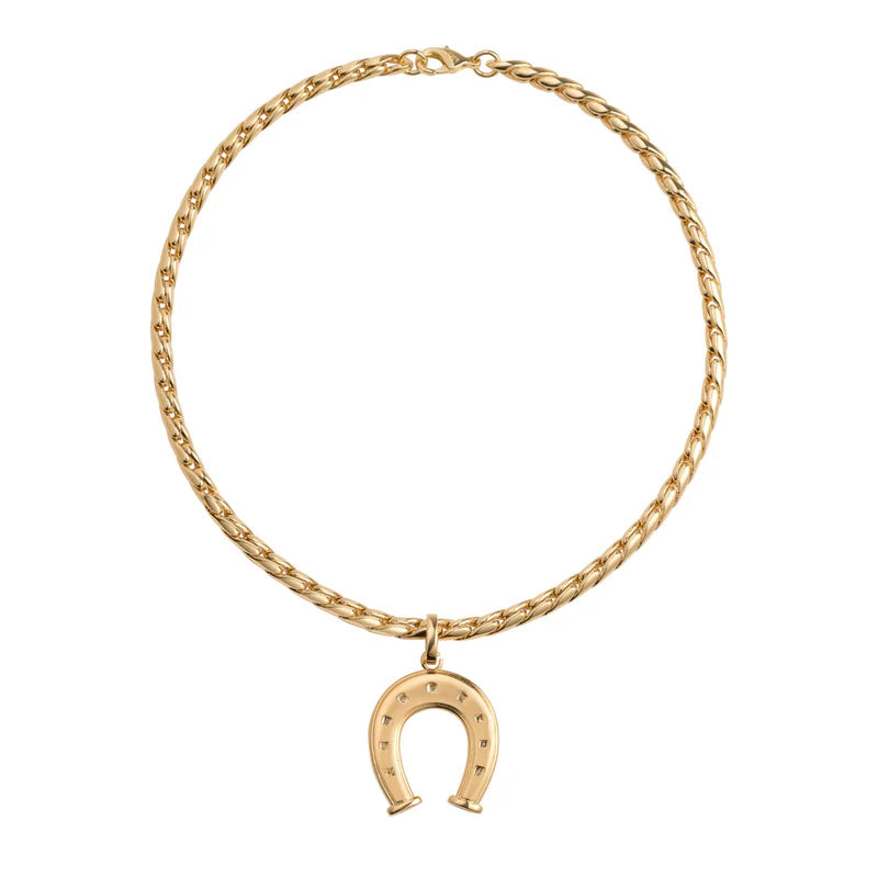 Gold chain necklace with a horseshoe pendant on a white background