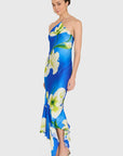 model wearing a blue dress with white flowers on a white background