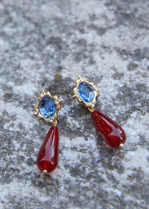 Via Earrings laid on granite