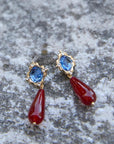 Via Earrings laid on granite