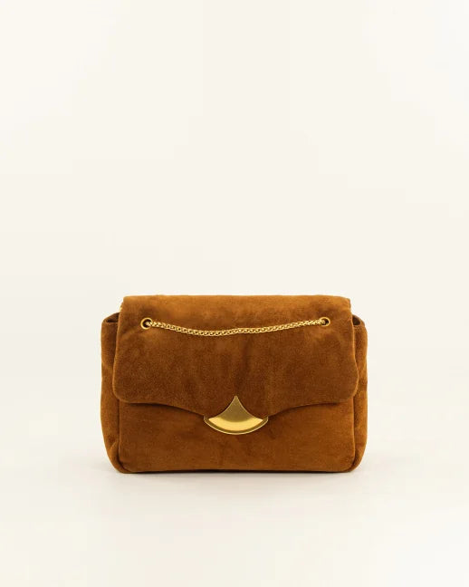A brown suede shoulder bag with a gold-tone chain strap and a gold-tone fan-shaped clasp, shown against a plain off-white background.