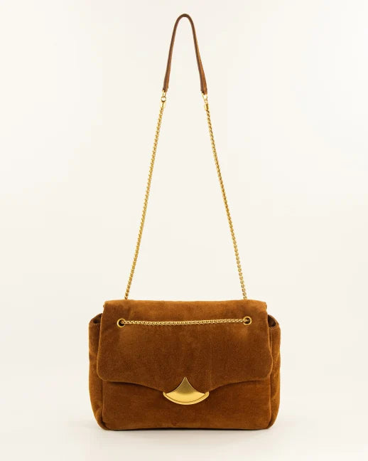 A brown suede shoulder bag with a gold-tone chain strap and a gold-tone fan-shaped clasp, shown against a plain off-white background.