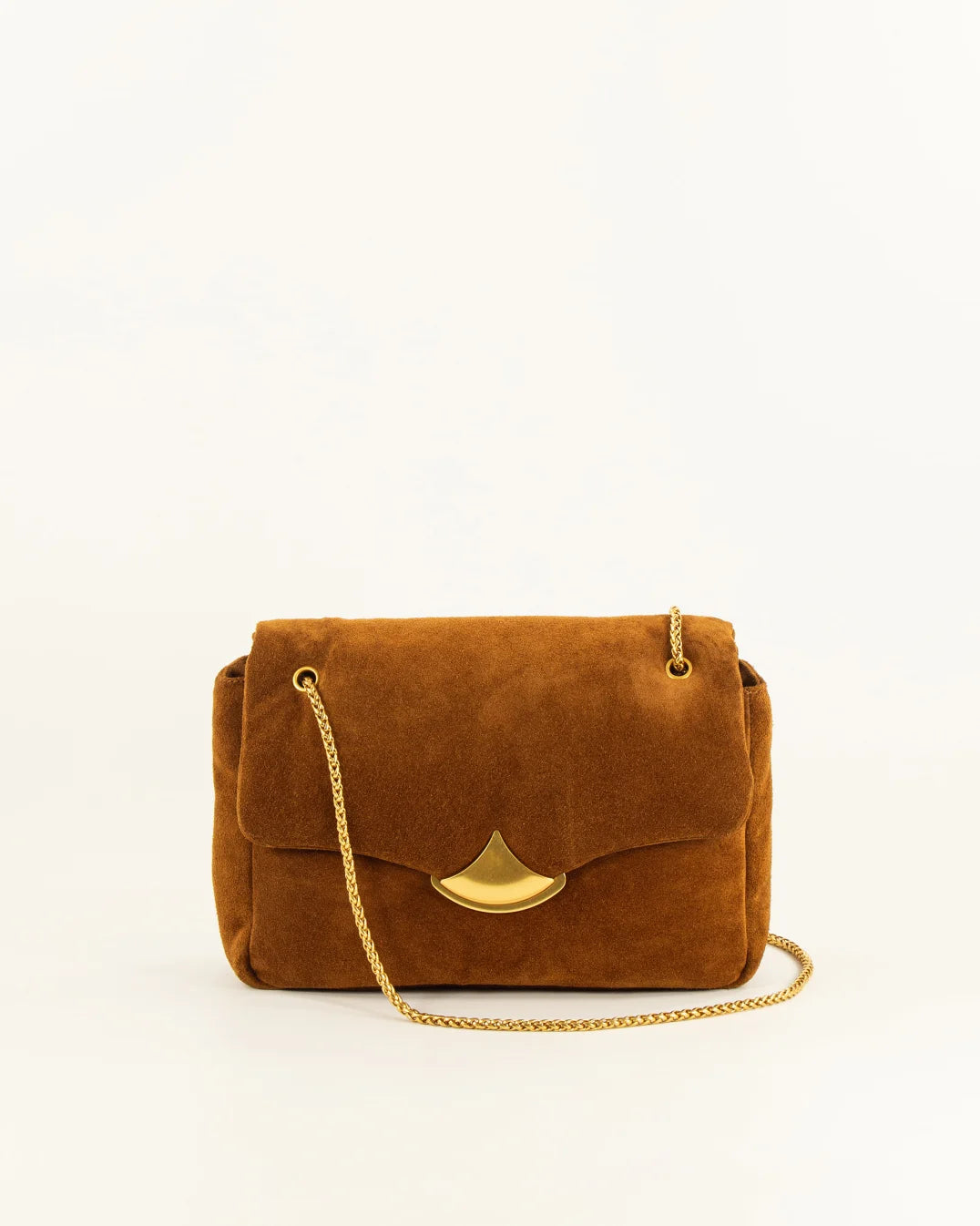 A brown suede shoulder bag with a gold-tone metal clasp and a gold chain strap, photographed against a plain white background.