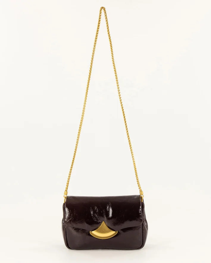 A dark brown glossy patent leather shoulder bag with a gold-tone chain strap and a gold-tone fan-shaped clasp, shown against a plain white background.