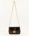 A dark brown glossy patent leather shoulder bag with a gold-tone chain strap and a gold-tone fan-shaped clasp, shown against a plain white background.