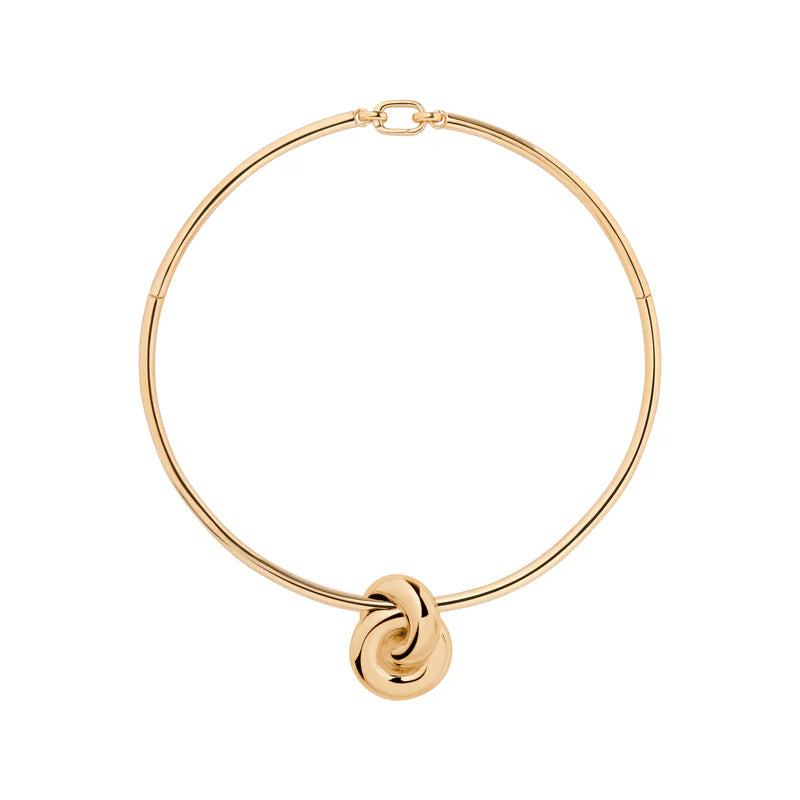Gold necklace with a knot pendant on a white background