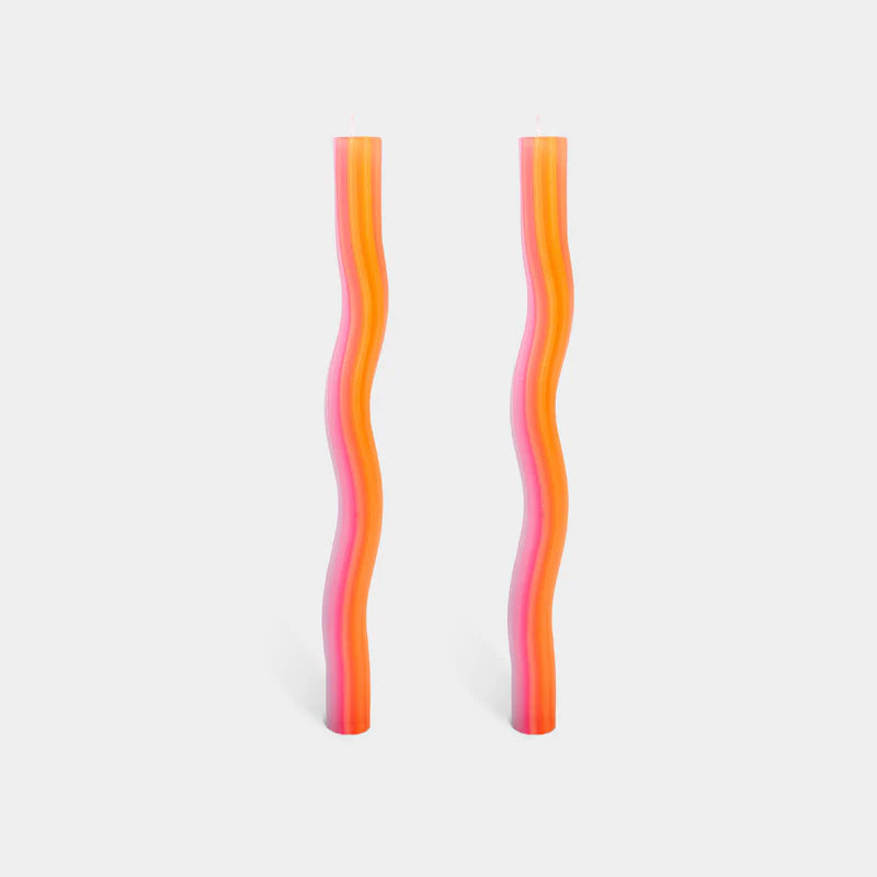 Two wavy, multicolored straws on a light gray background