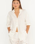 Woman wearing a white shirt and shorts set on a white background