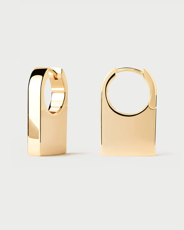 Gold hoop earrings on a light gray background