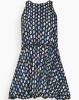 A sleeveless, tiered mini dress with a dark navy blue base and an all-over white and light blue circular floral pattern, shown against a plain white background.