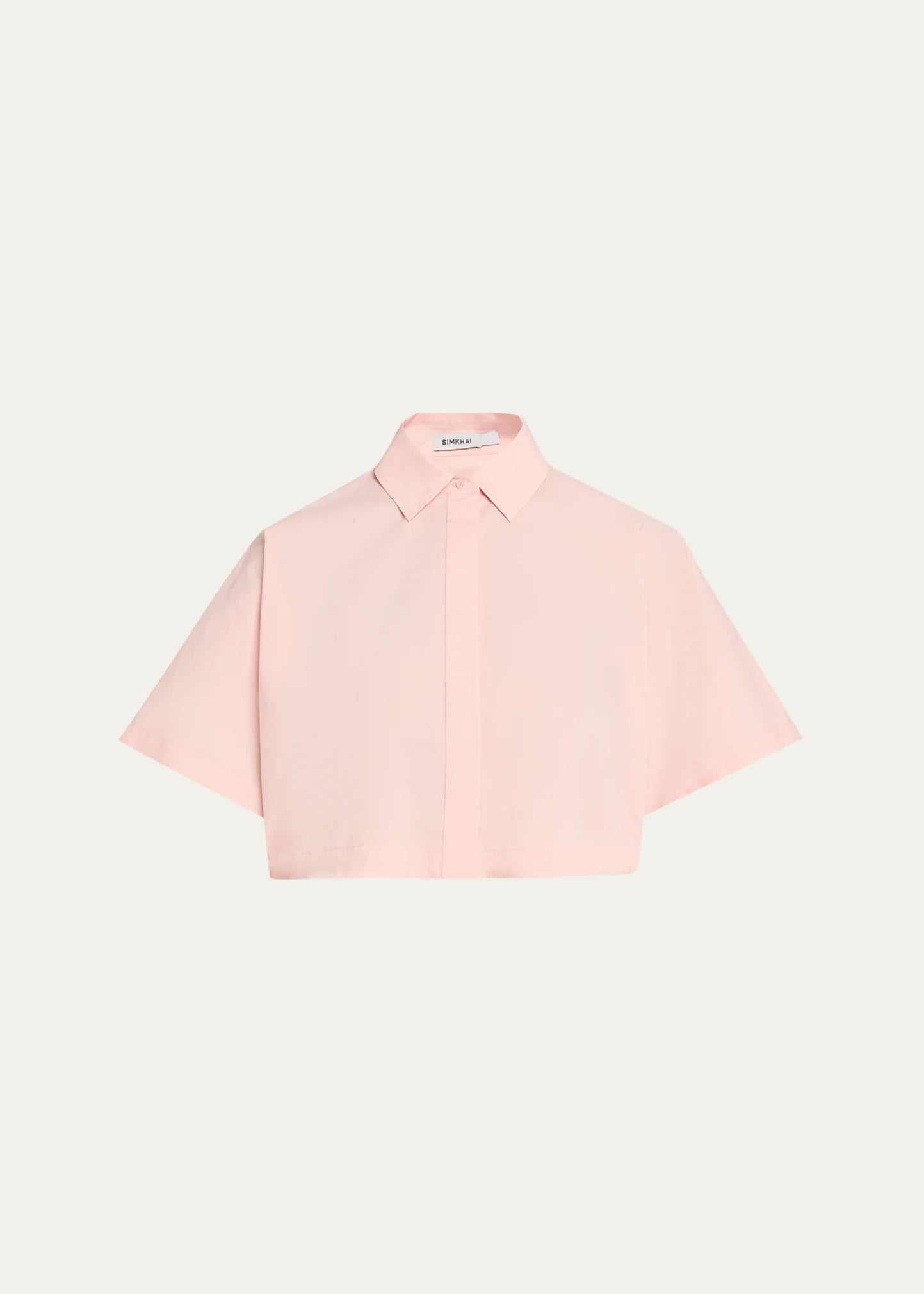 A light pink short-sleeve button-up shirt with a pointed collar, presented flat against a solid off-white background.