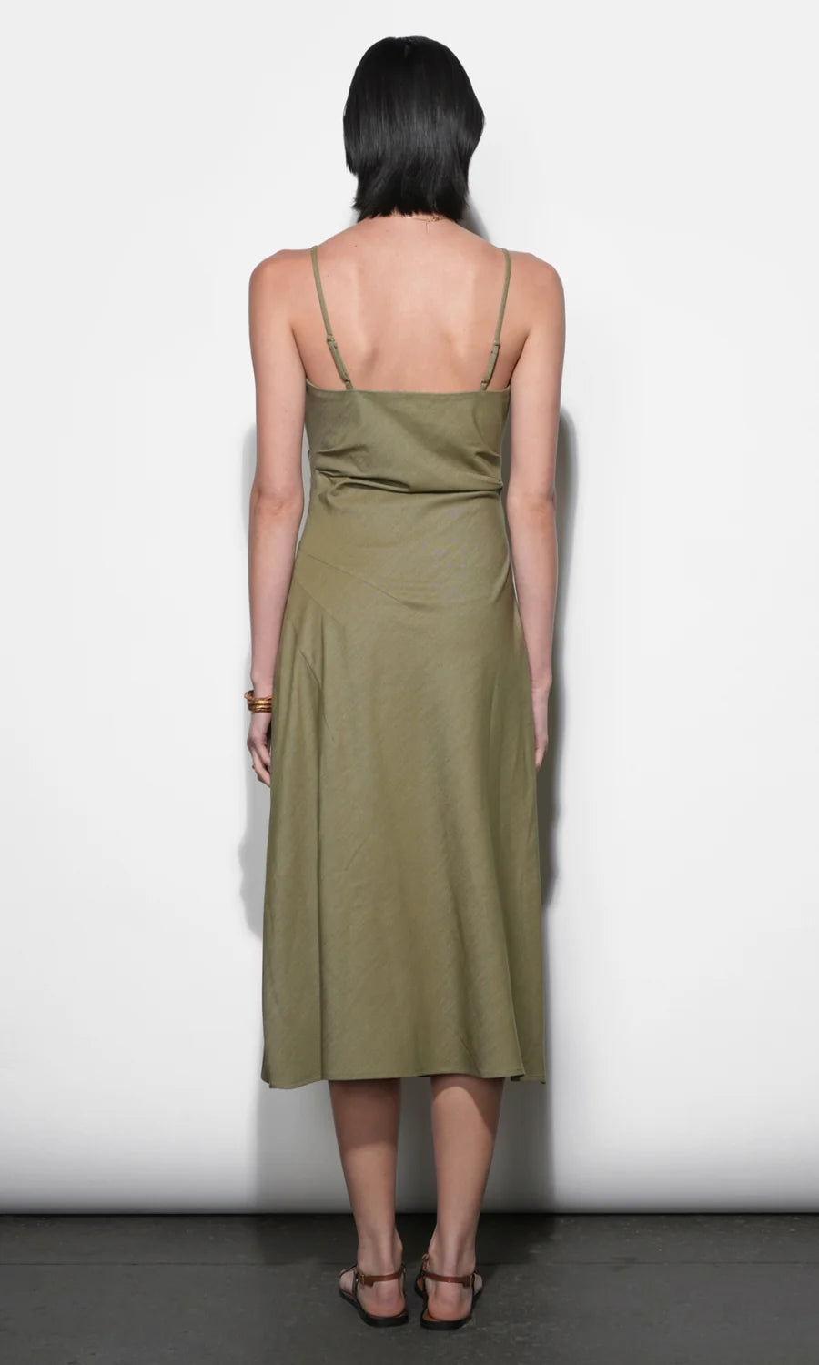 Woman wearing a green dress against a white background
