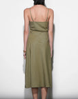Woman wearing a green dress against a white background