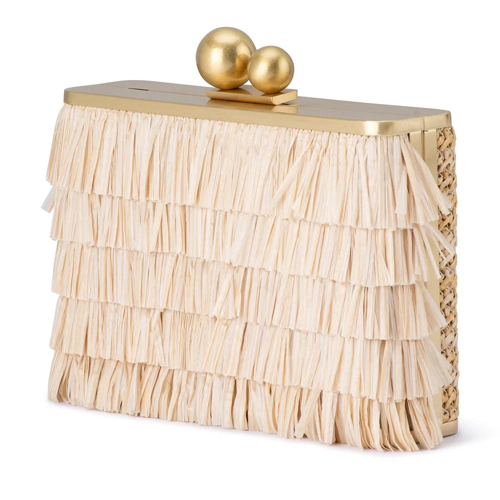 A gold and beige clutch bag featuring a tiered beige raffia fringe body, a gold metal top frame, two gold decorative spheres on top