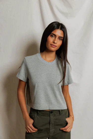 model wearing a heather grey t shirt and green pants on a white background