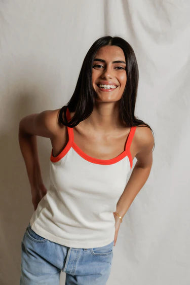 model wearing a tank and jeans  against a white background