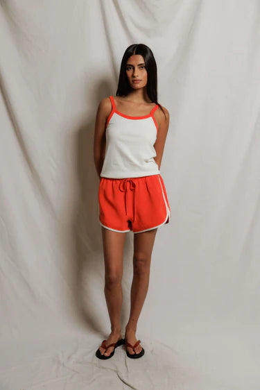 model wearing a matching tank and short set on a white background