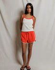 model wearing a matching tank and short set on a white background