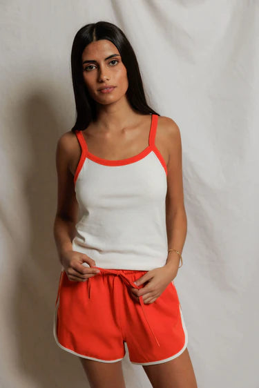 model wearing a matching tank and short set on a white background