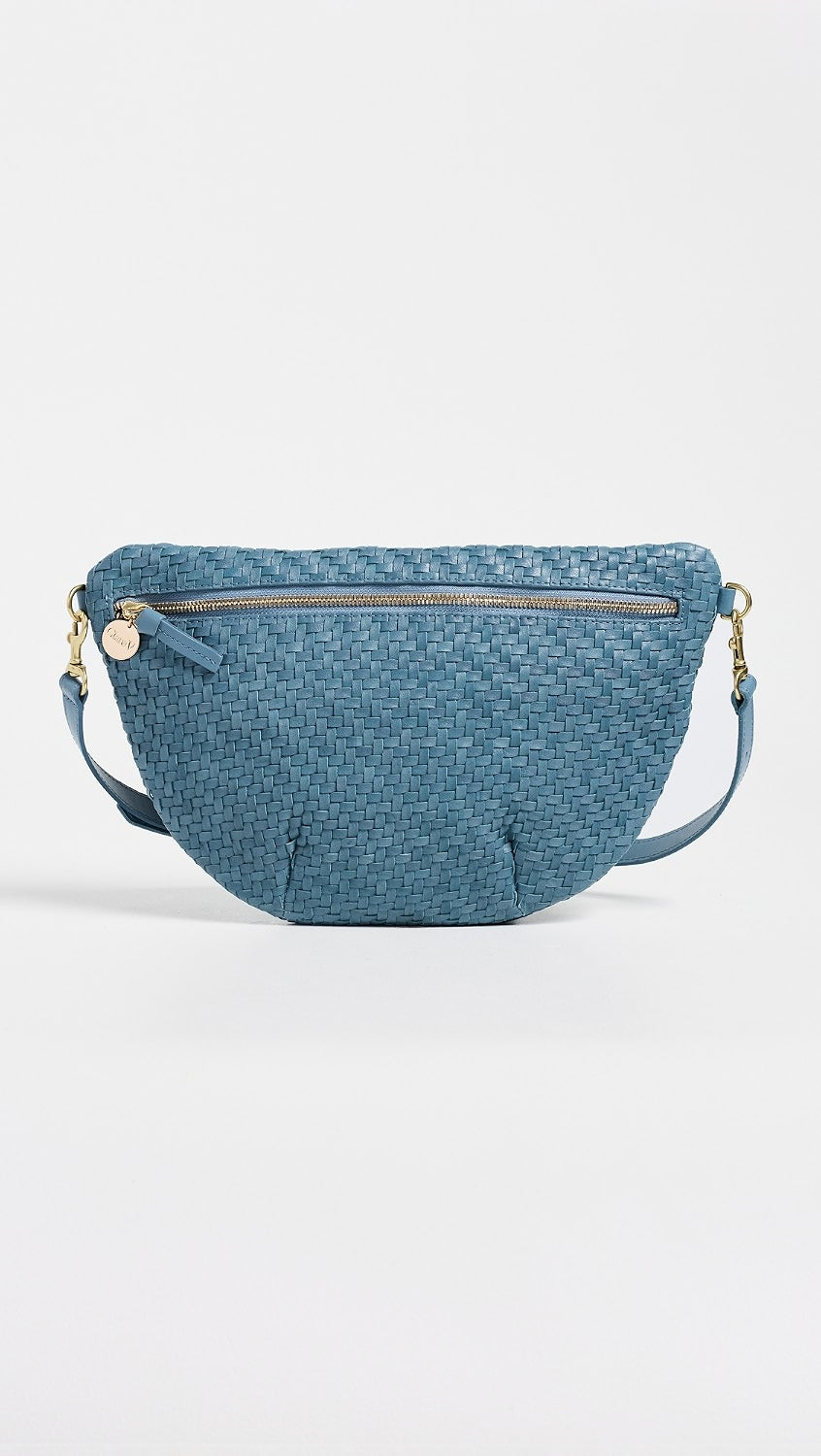 A blue woven leather belt bag with a top zipper, gold-tone hardware, and a matching shoulder strap, shown against a plain white background.