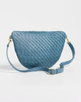 A blue woven leather crescent-shaped shoulder bag with a matching adjustable shoulder strap and gold-tone hardware, photographed on a clean white background.
