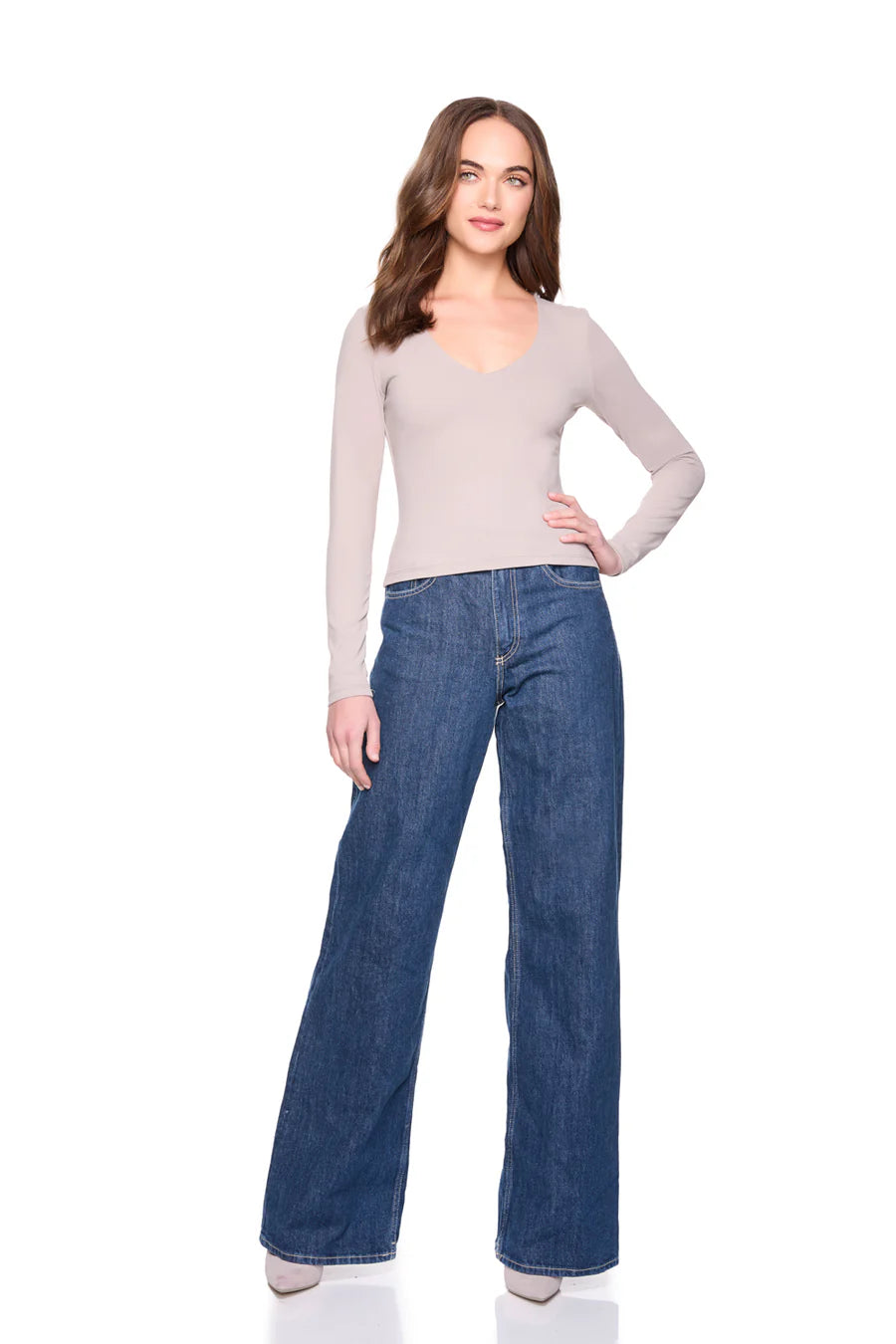 vneck long sleeve top in sandstone on a model wearing jeans with a white background