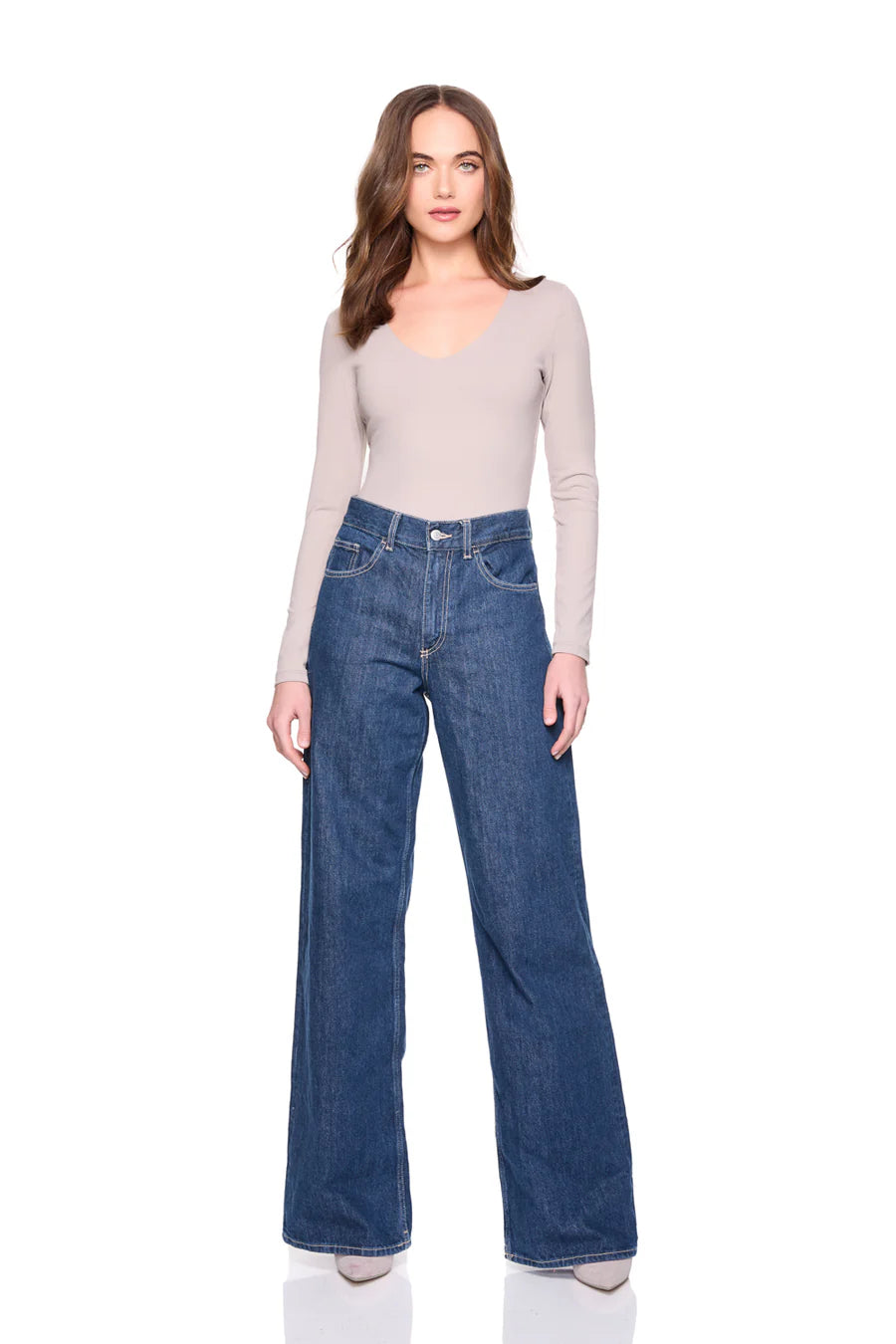 vneck long sleeve top in sandstone on a model wearing jeans with a white background