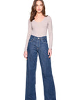 vneck long sleeve top in sandstone on a model wearing jeans with a white background