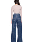 vneck long sleeve top in sandstone on a model wearing jeans with a white background back view