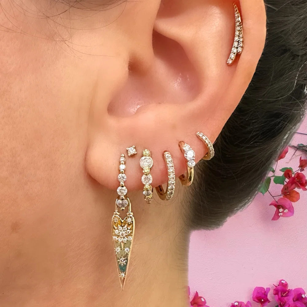 Single Tiny Pave Hoop on model's ear with a bunch of other earrings