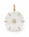 A gold pendant featuring a large, scalloped white mother-of-pearl flower with a central iridescent opal and small clear stones along the petal edges and bail, set against a plain white background.
