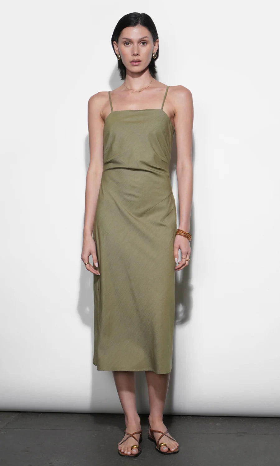 Woman wearing a green dress against a white background