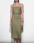 Woman wearing a green dress against a white background