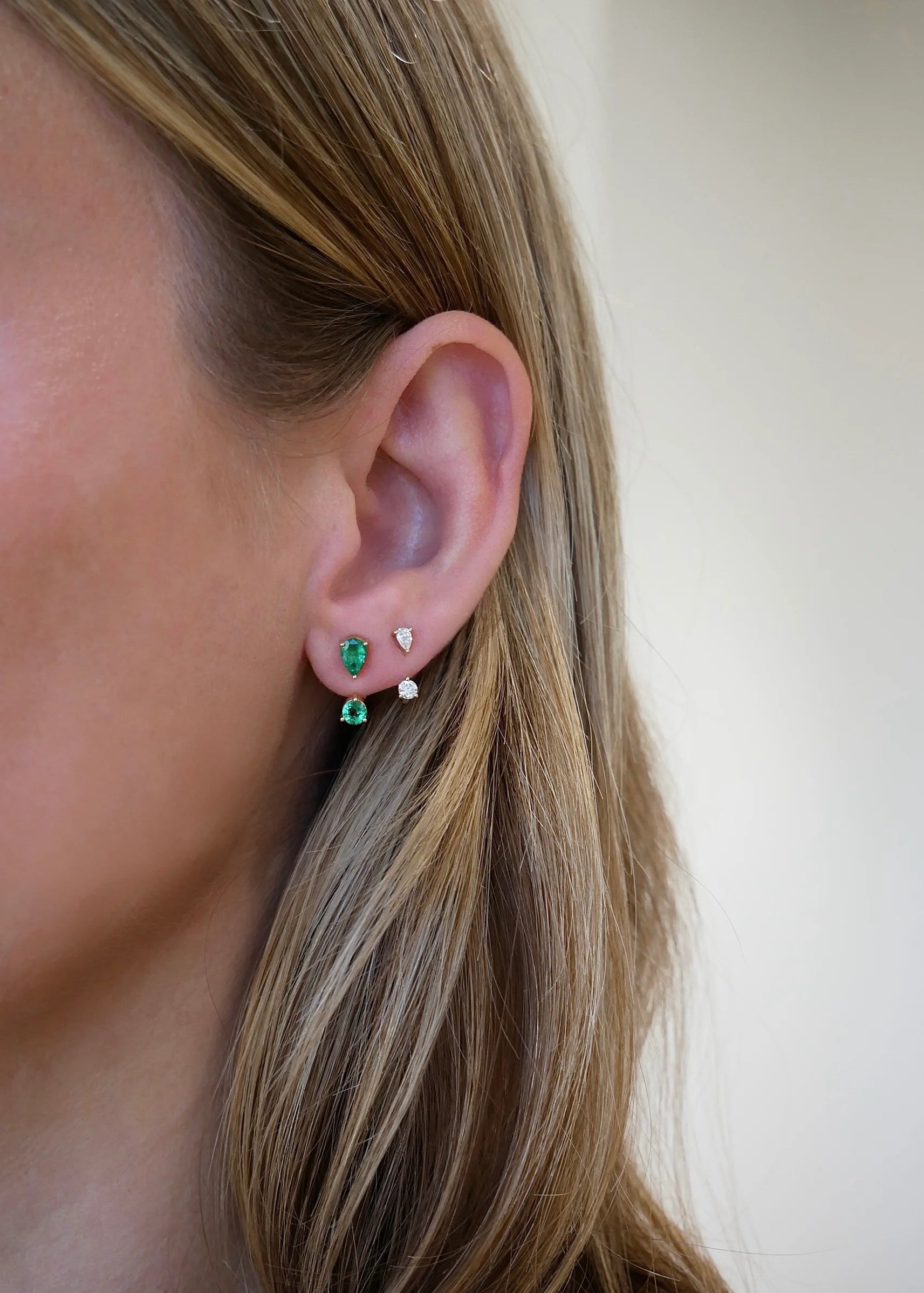 Single Diamond Pear and Round Illusion Stud Earring on ear in second hole