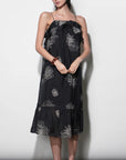 model wearing the Paige Layered Ruffle Midi Dress with strappy sandals on a white background, front 