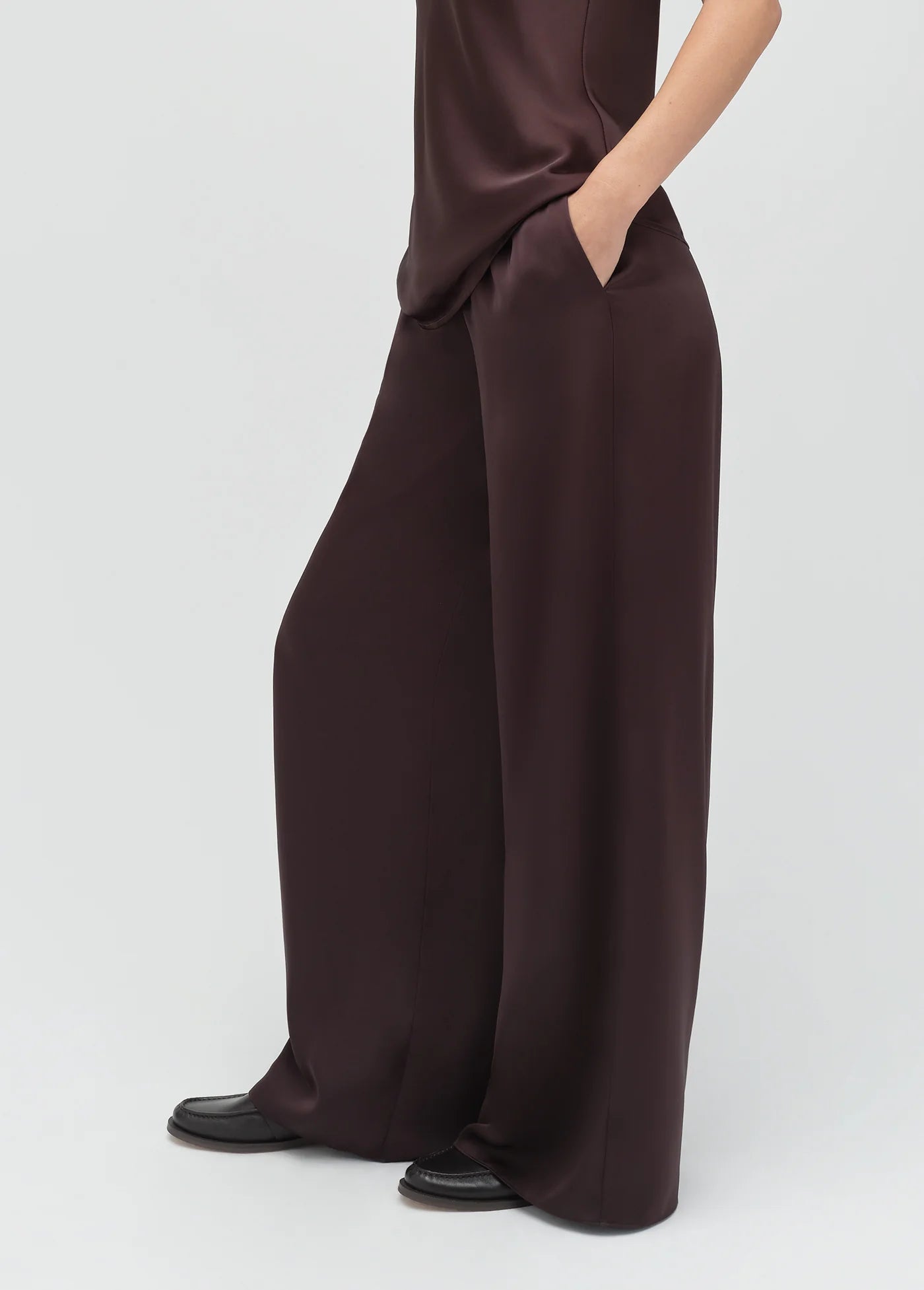 Brown jumpsuit worn by a person on a white background