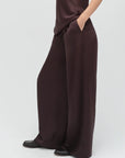 Brown jumpsuit worn by a person on a white background