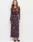 Woman wearing a floral dress with a plain background front view