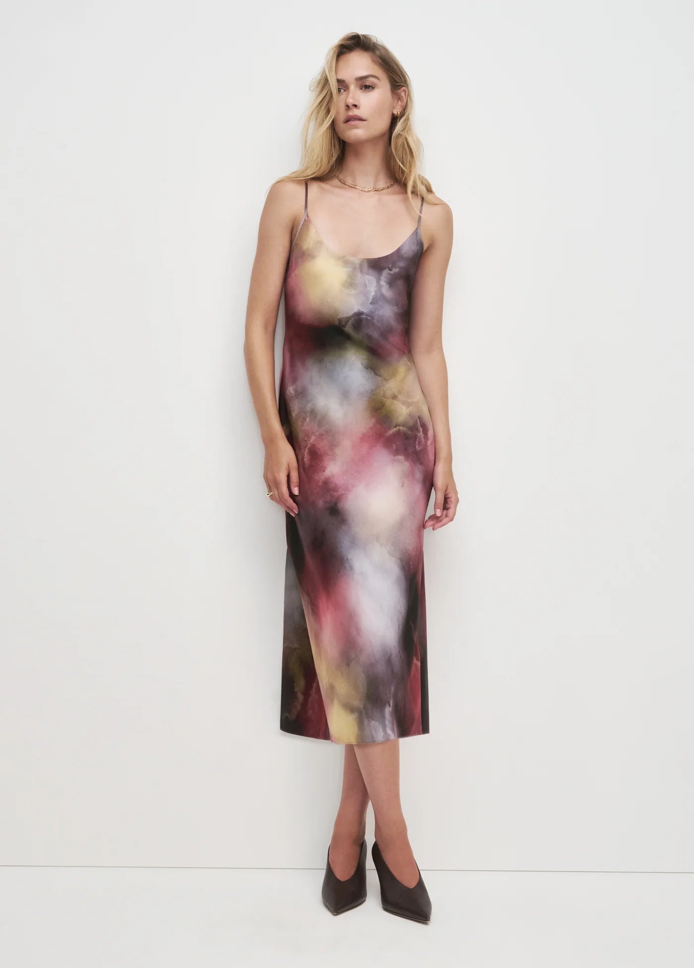 Woman wearing a colorful slip dress on a white background