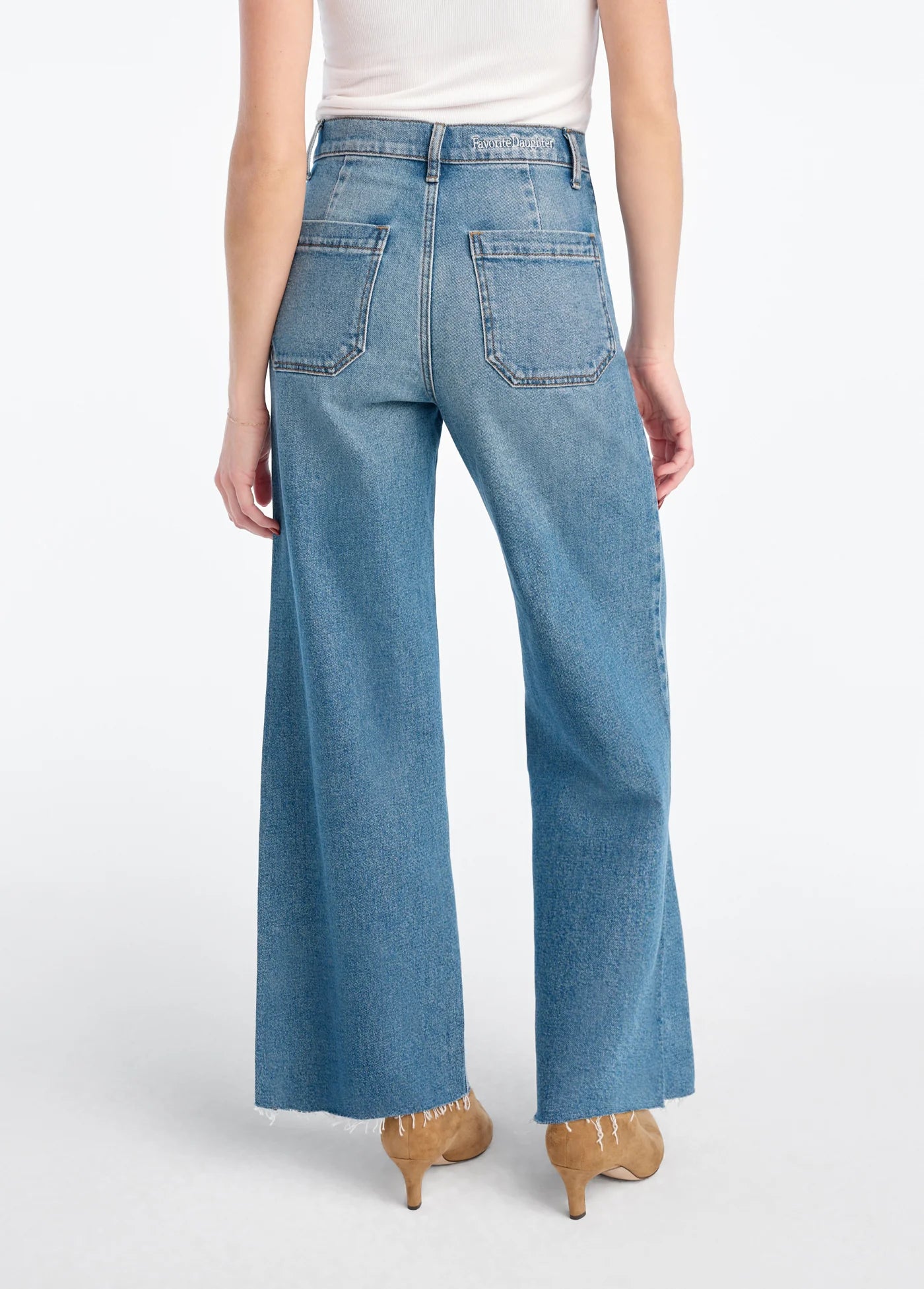 Blue jeans worn by a person on a white background, back 