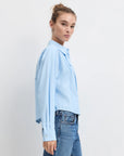 Model wearing the light blue stripe jenni top with jeans on a white background, side