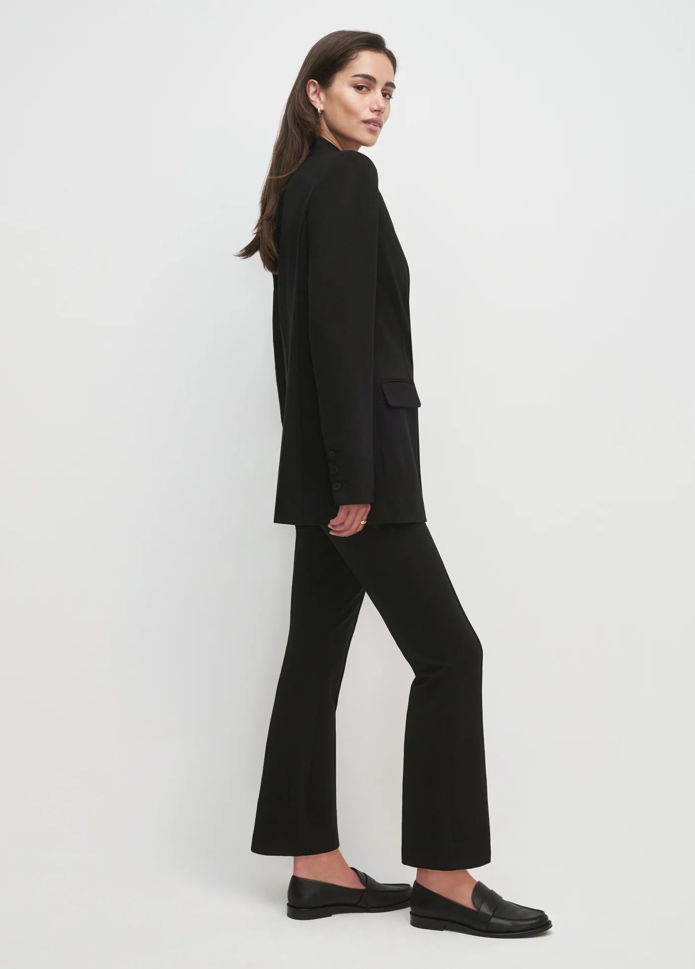 Women wearing black blazer and black pants with white background