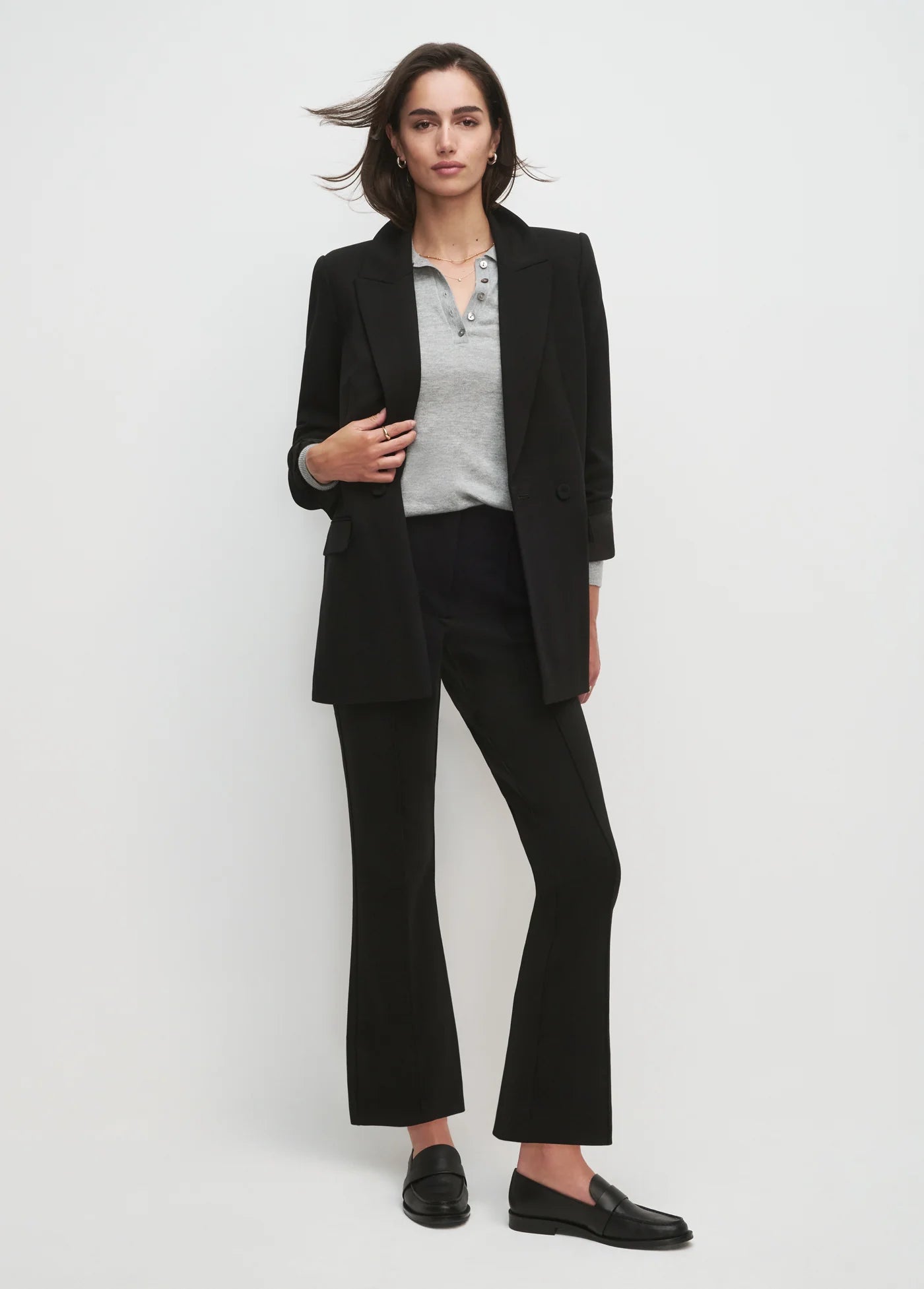 Women wearing black blazer and black pants with white background