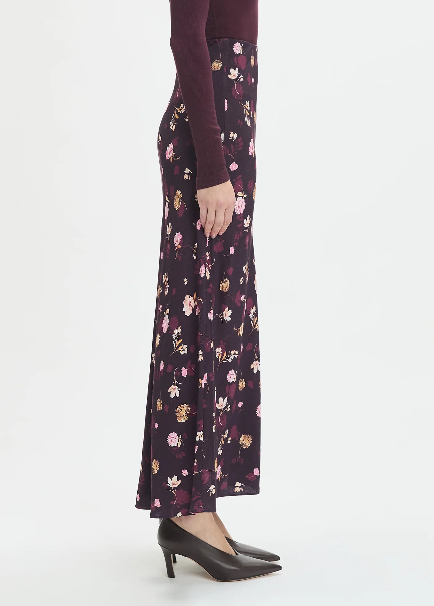 Floral patterned skirt worn by a person on a white background side view
