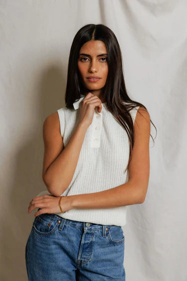 model wearing a white collared shirt with jeans on a white background