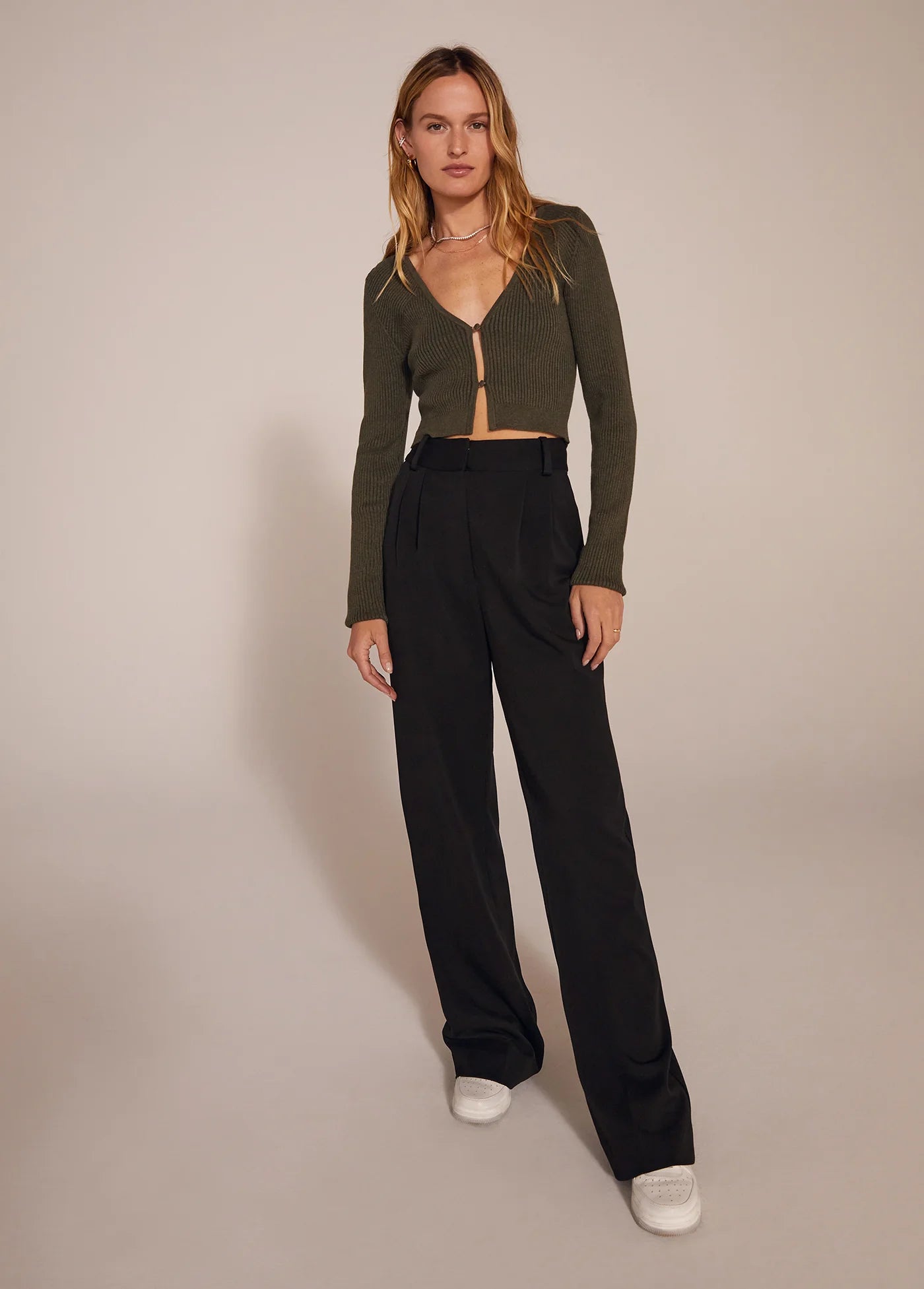 The Favorite Pant in Black full body with green sweater