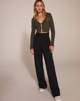The Favorite Pant in Black full body with green sweater