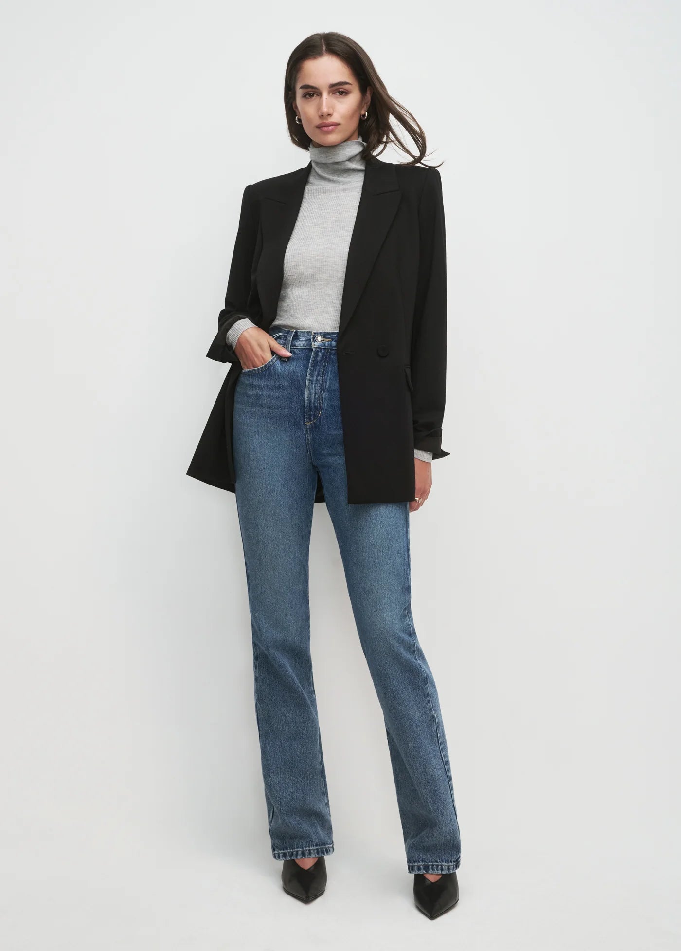 Women wearing black blazer and black pants with white background