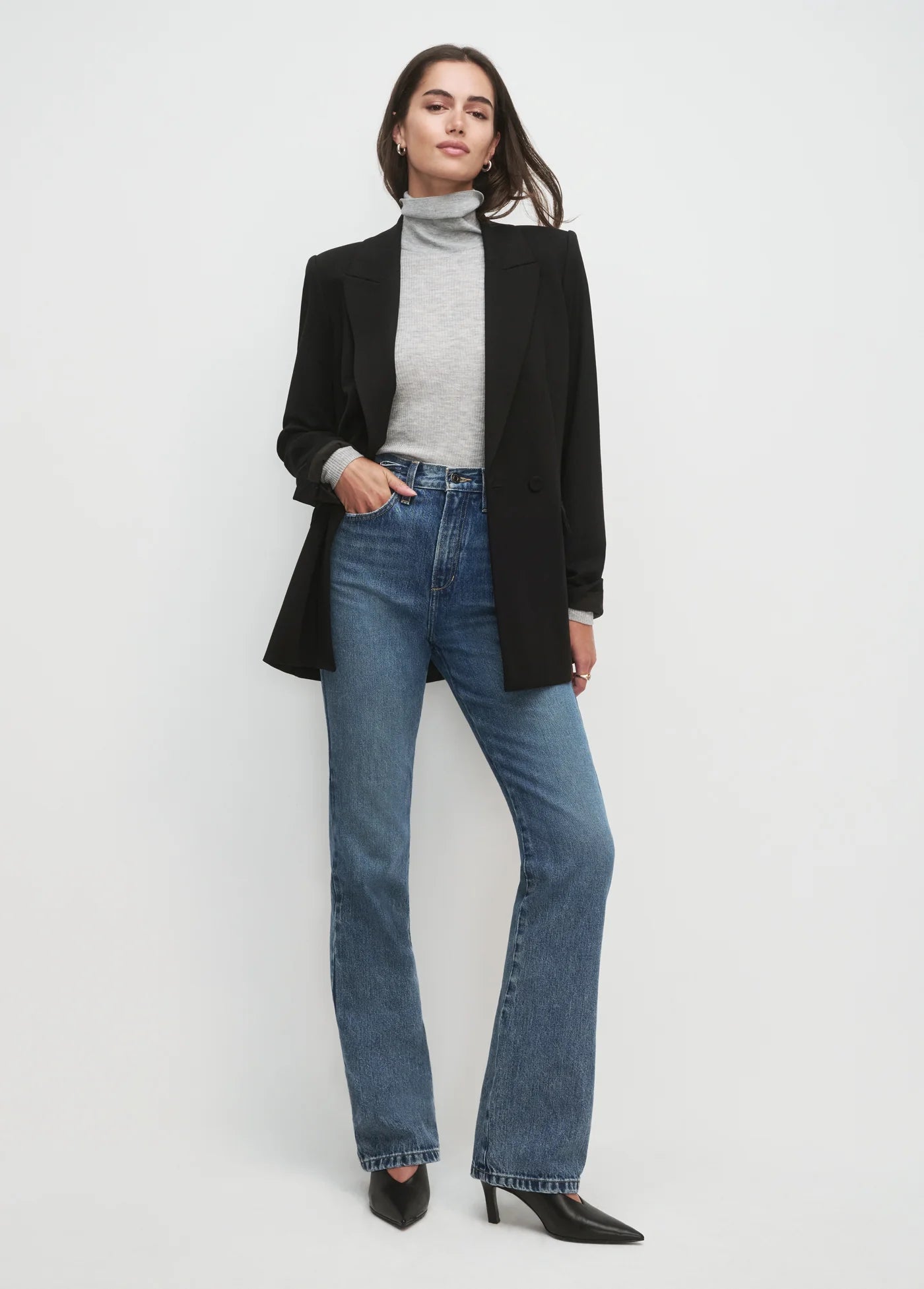 Women wearing black blazer and black pants with white background