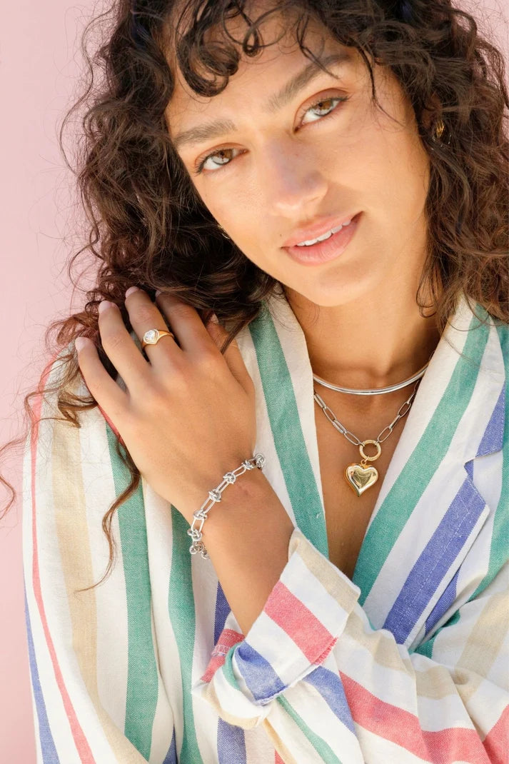 It Girl Heart Necklace on model with striped shirt